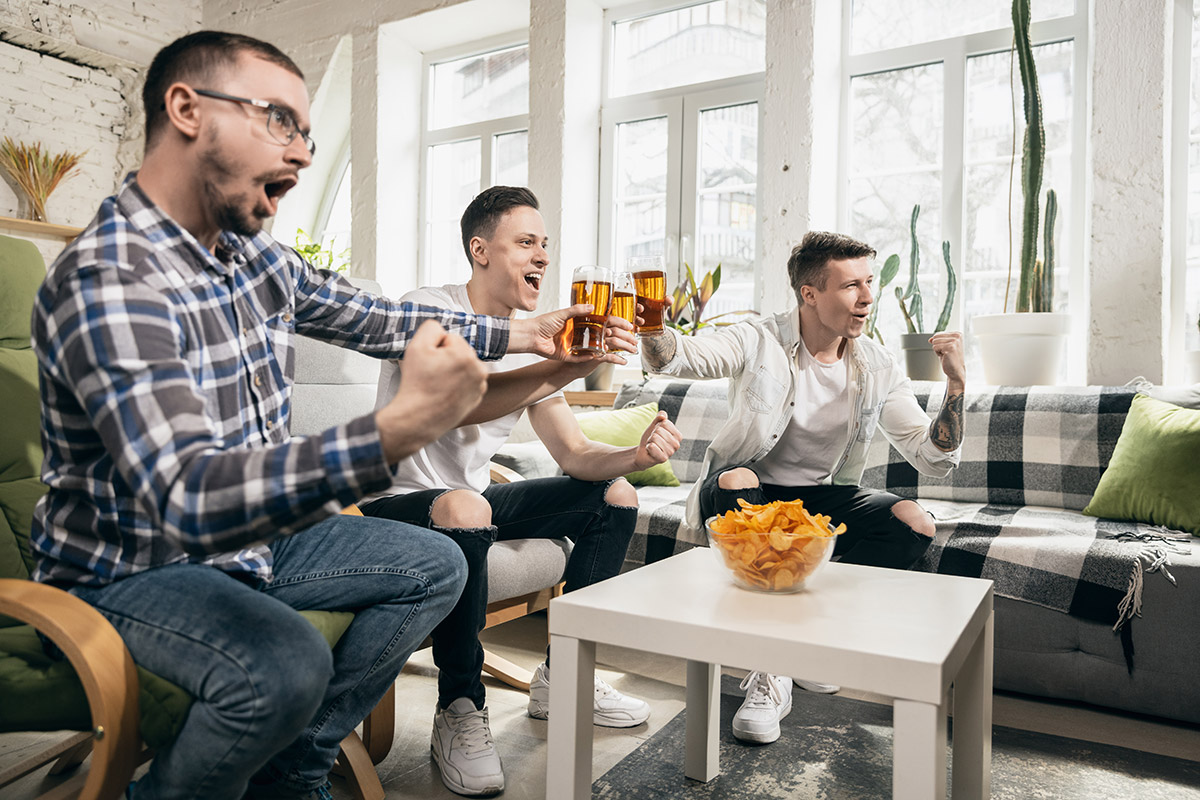 Group of friends watching sport match together. Concept of friendship, leisure activity, emotions 