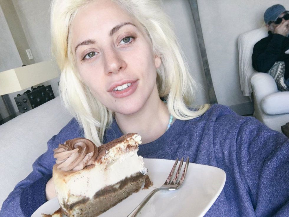 Lady Gaga without makeup holding a food plate in her hand