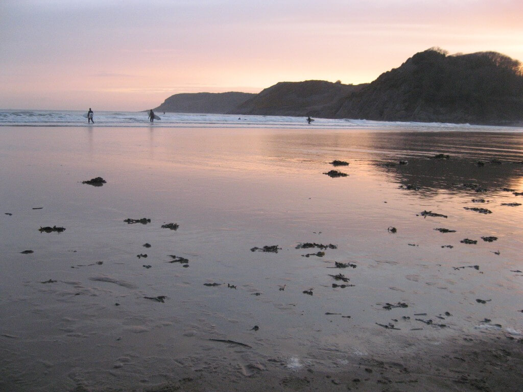 Caswell Bay at dusk a great place to surf on holiday