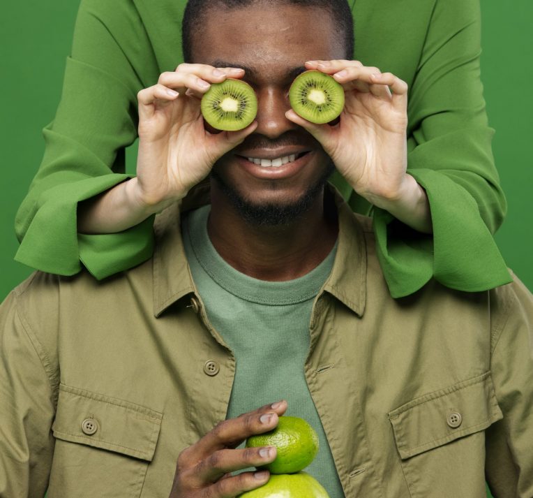 portrait-man-with-woman-holding-green-fruits