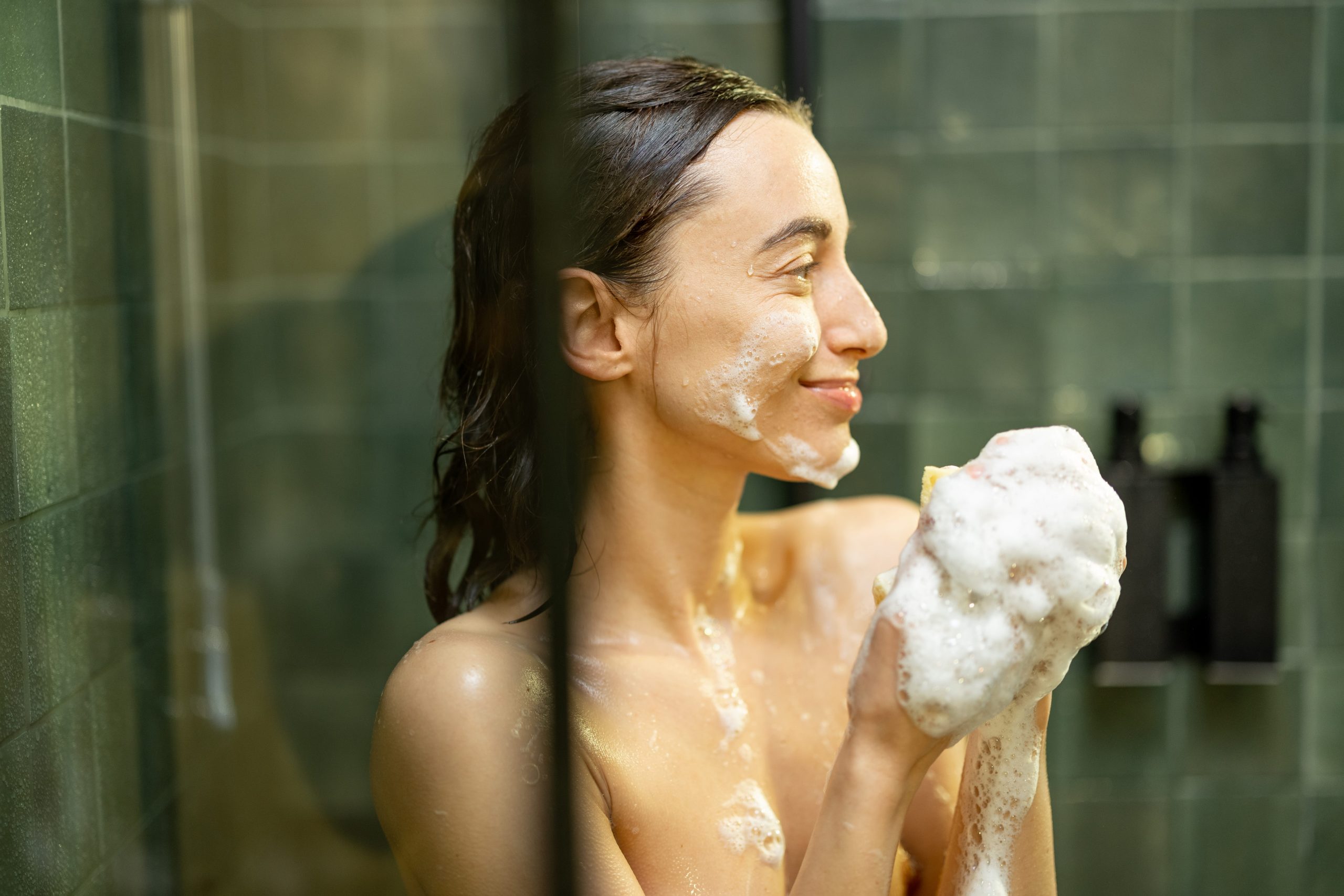 woman taking shower and soaping the body with show 2023 11 27 04 49 07 utc scaled