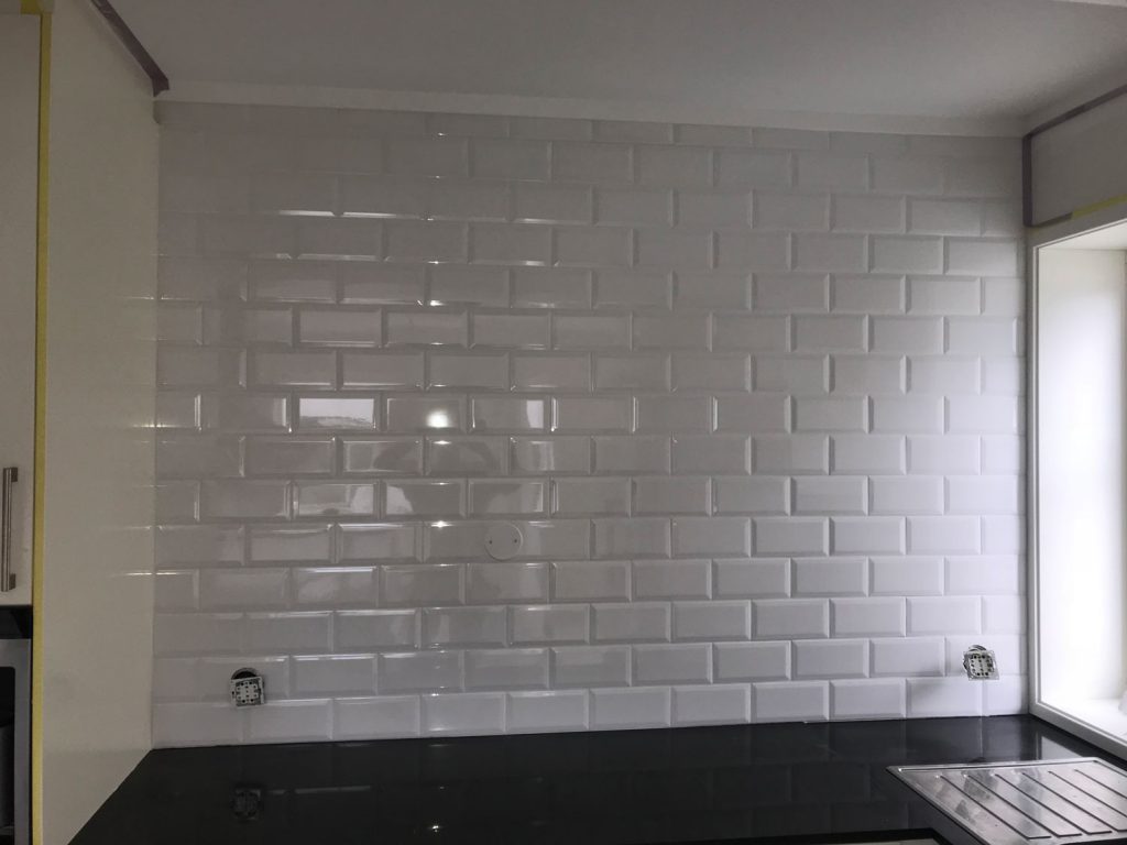Paint the living room and tile a wall in the kitchen.