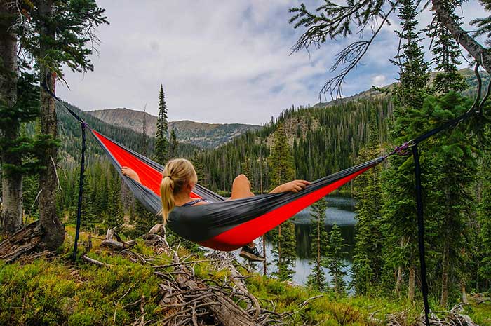girl hammock camping in a valley