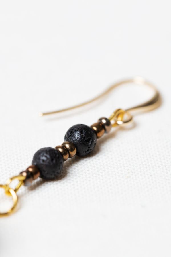 Asymmetrical golden earring set with lava stone and golden beads
