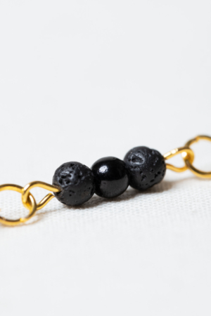Golden earring set with lava stone and black glass beads