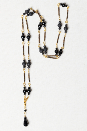 Long golden necklace with black beads and lava stones