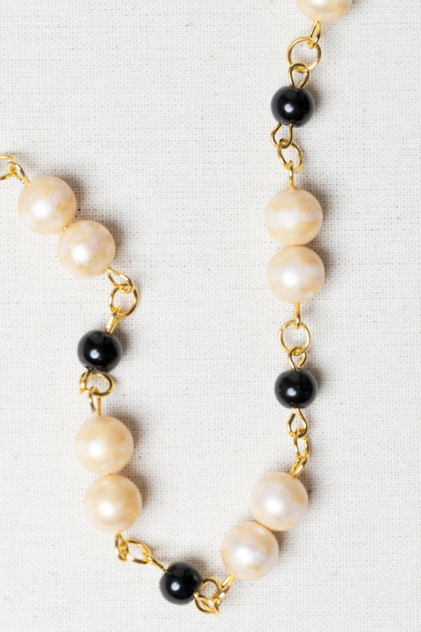 Golden necklace with vintage pearls and black glass beads