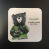 The Exercise Bear Coaster showcases a cartoon bear in a green striped shirt, humorously holding fries. The bear appears to be pondering an amusing thought: Exercise? I thought you said extra fries... This playful design is set against a square white background, perfect for those who love fitness humor and quirky home decor.