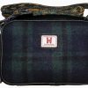 Discover our stylish rectangular crossbody bag, showcasing a trendy dark plaid pattern in green and blue. This eye-catching accessory features a distinctive small white and red emblem centrally located on the front. It comes complete with an elegant patterned strap and is enhanced by a chic black tassel attached to the zipper, making it the perfect addition to your wardrobe. Ideal for fashion-savvy individuals seeking a blend of functionality and style in their handbags collection!.