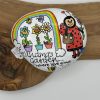 A charming painted rock featuring a ladybug with a watering can, three vibrant potted flowers, and a colorful rainbow. The phrase Grandmas Garden... where love grows is beautifully displayed on the wooden surface. Perfect for adding a touch of whimsy to your garden decor!.
