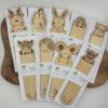 Explore our unique collection of engraved wooden bookmarks featuring illustrations of deer, kiwi, and rabbit. These exquisite bookmarks are presented on a premium wooden surface with branded packaging, bringing the charm of nature to enhance your reading experience.