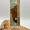 Discover our Hand-Painted Wooden Bookmark featuring an enchanting Highland Cow design. This artisanal bookmark is elegantly displayed on a clear stand, complete with the product name for easy identification. Its minimalist charm not only highlights its handcrafted appeal but also makes it the perfect gift for book lovers and reading enthusiasts searching for unique and thoughtful presents.