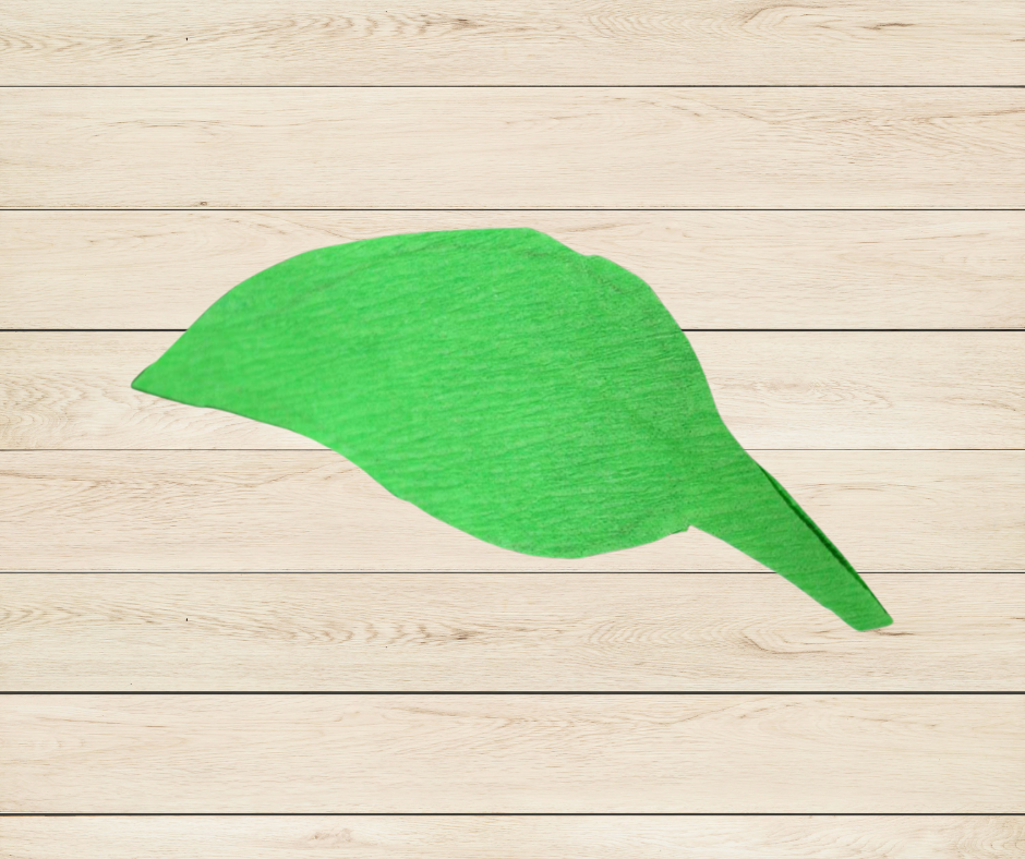 Een uitgeknipt groen blaadje uit crêpepapier.