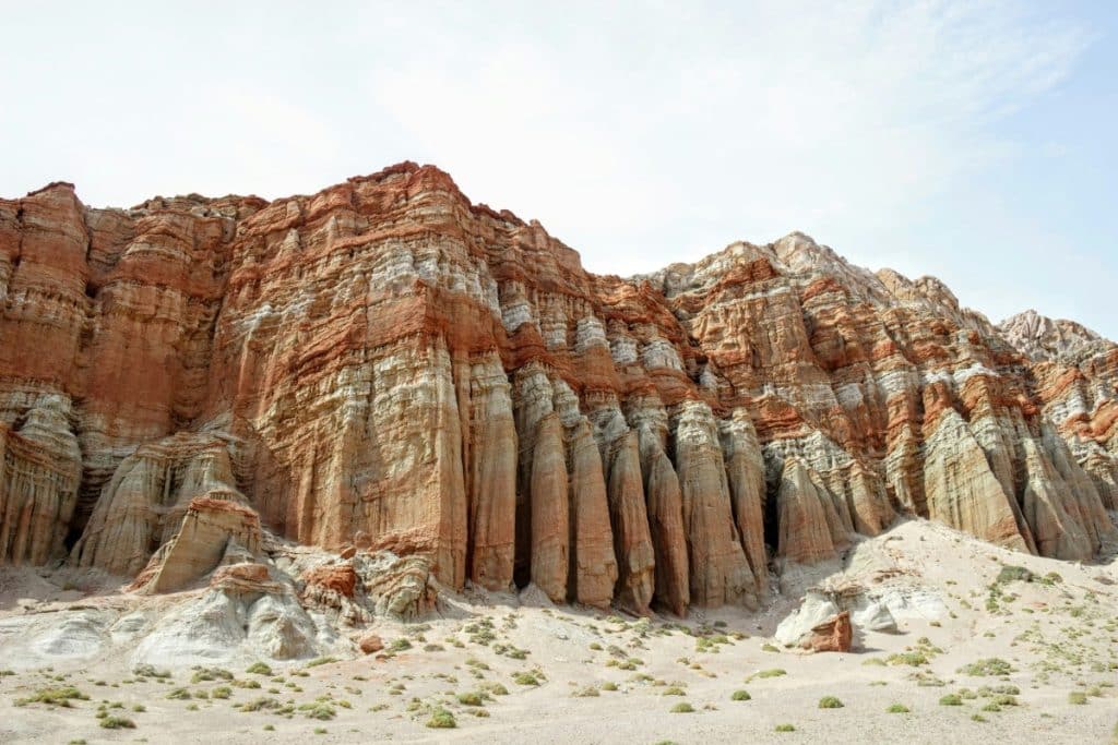 A mountain chain where you see the different layers of soil and rock formations.