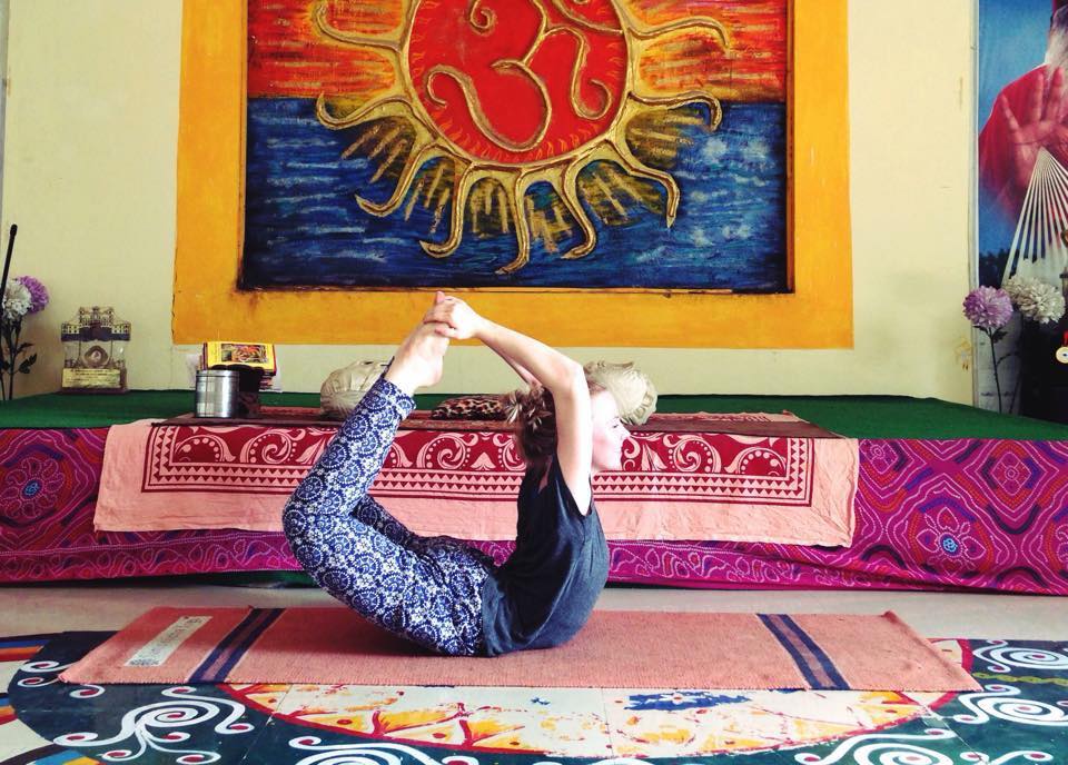 Girl practicing yoga in colorful room.