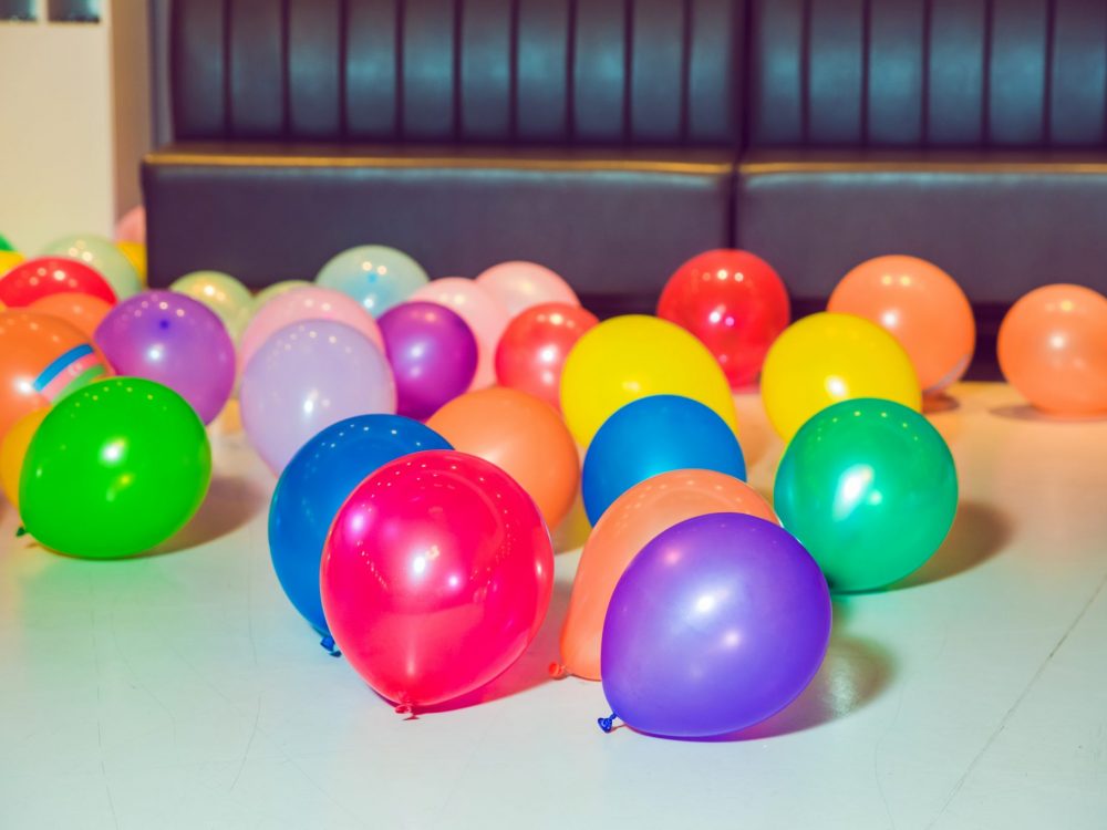 Different color balloons on the floor . Flat lay of colorful balloons . holiday, children's party, a games room, a box filled with small colored balls