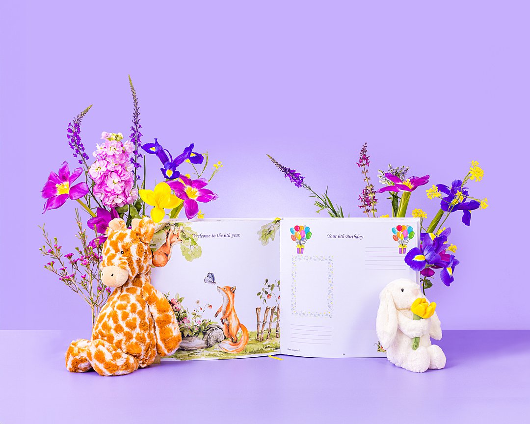 Colourful product photography for Bali Vaughn Story of Us baby book with floral styling. Floral styling and still life photography by HIYA MARIANNE photo production studio.