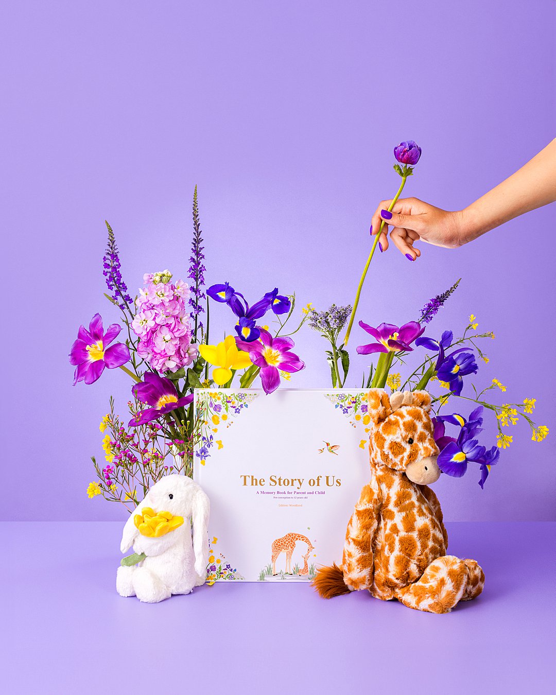 Colourful product photography for Bali Vaughn Story of Us baby book with floral styling. Floral styling and still life photography by HIYA MARIANNE photo production studio.