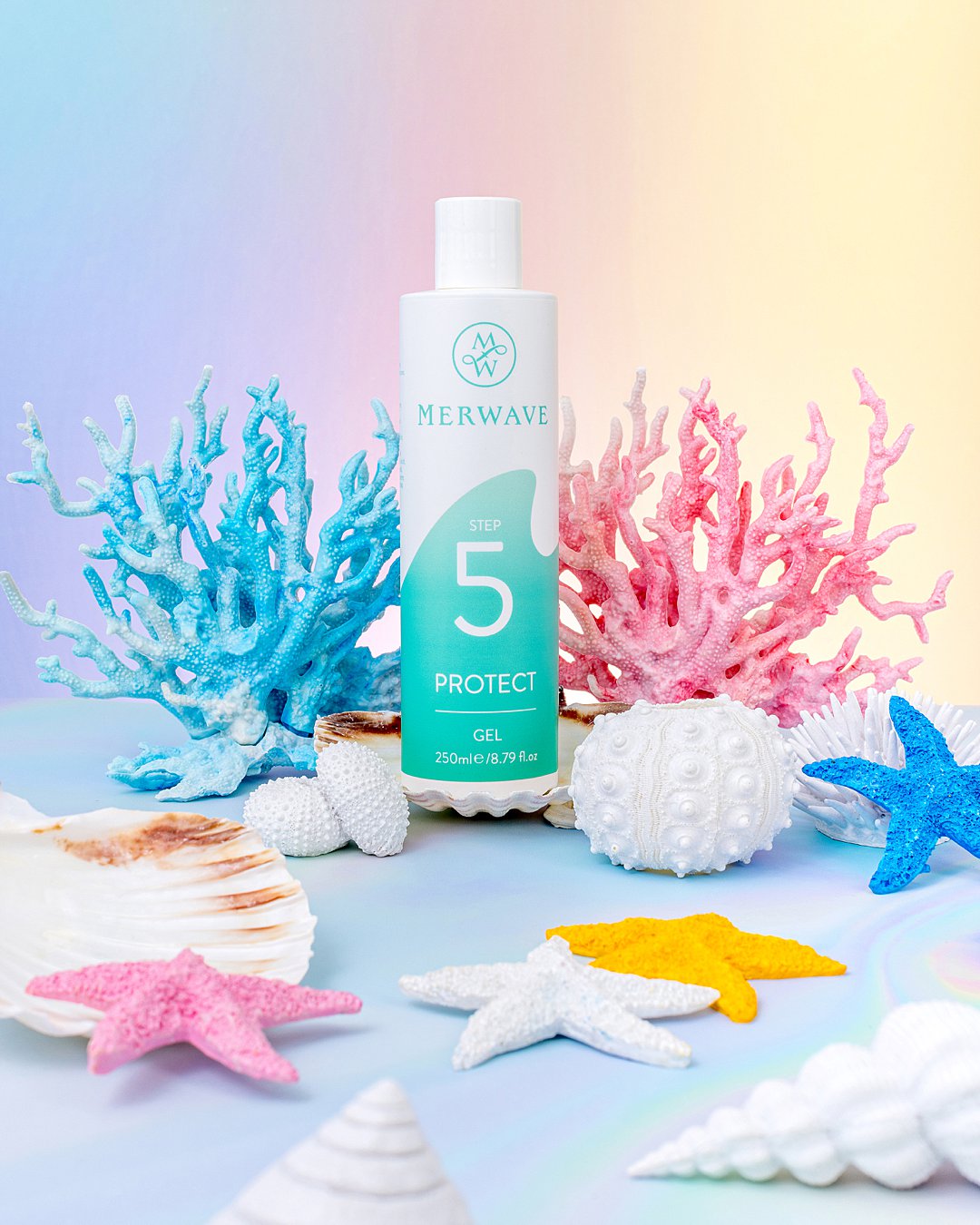 Colourful undersea product photography for Merwave wavy hair haircare products. Mermaid styling and still life photography by HIYA MARIANNE photo production studio.