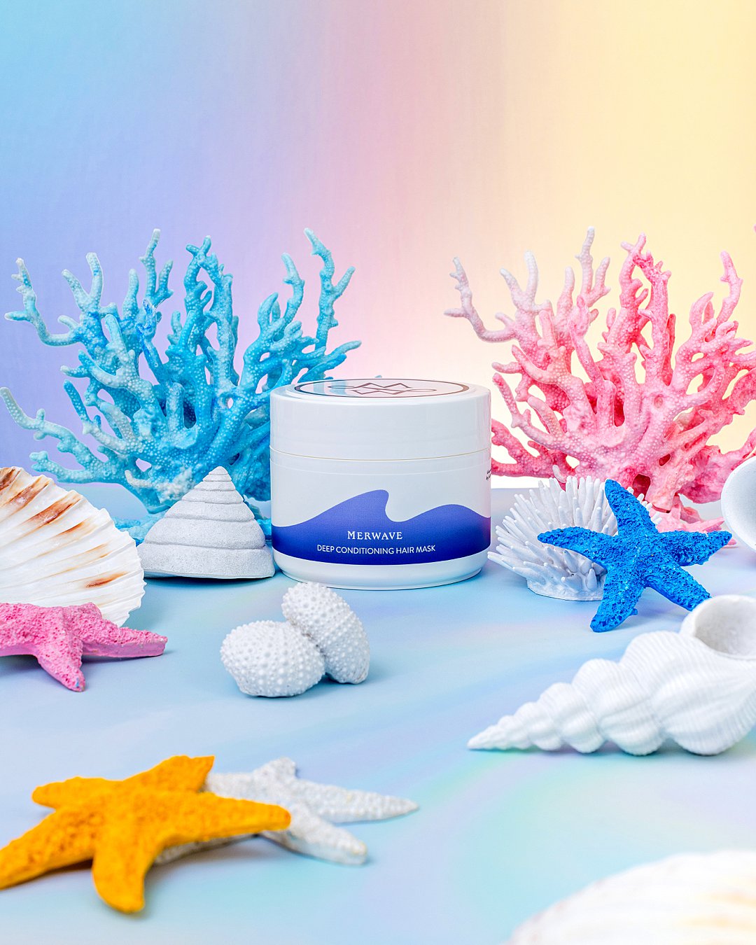 Colourful undersea product photography for Merwave wavy hair haircare products. Mermaid styling and still life photography by HIYA MARIANNE photo production studio.