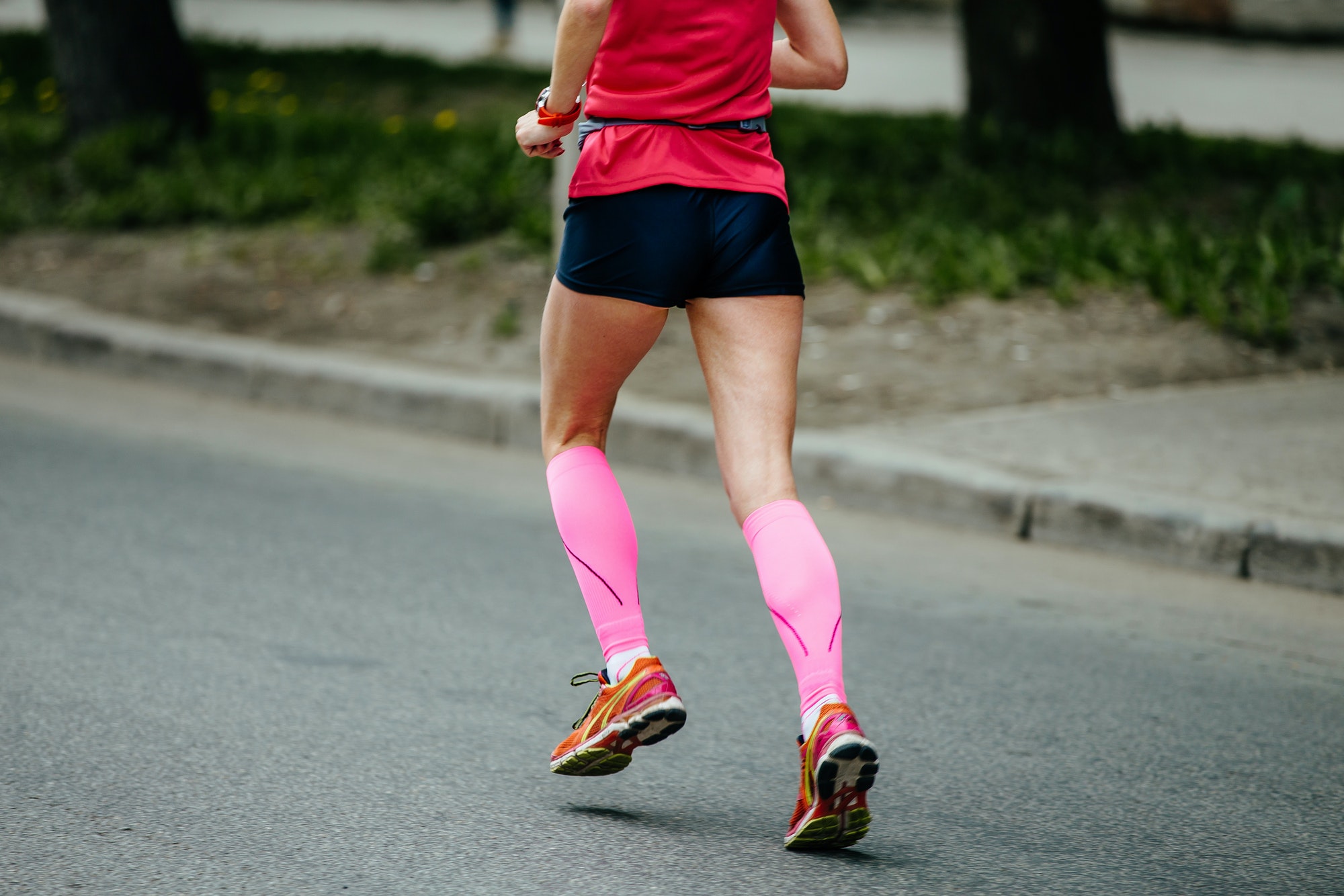 back runner girl in pink compression socks