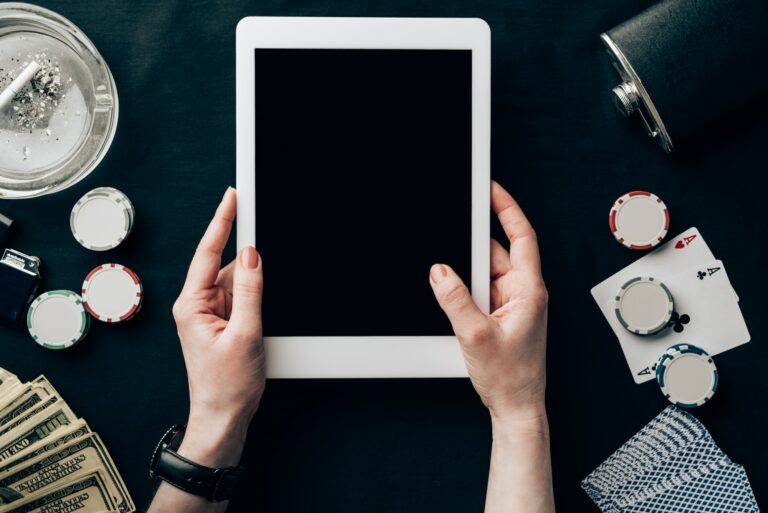 Female hands holding digital tablet on casino table