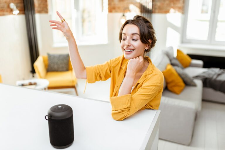 Woman controlling smart home devices with a voice commands