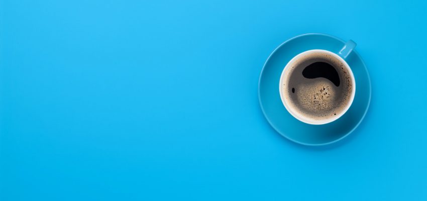 Blue coffee cup over blue background