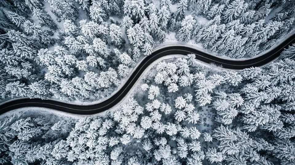 Winding road through a winter landscape, the same road in different conditions