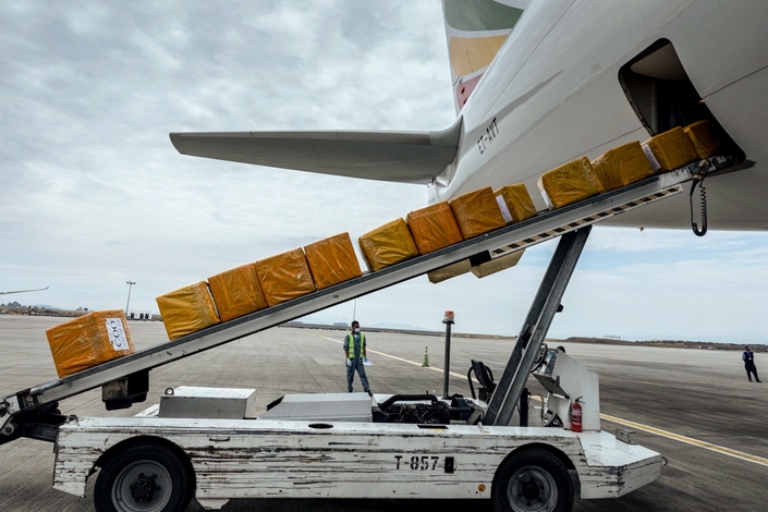 A cargo flight containing over 6 million medical items including face masks, test kits, face shields and protective suits arrives in the capital Addis Ababa, Ethiopia Sunday, March 22, 2020. The supplies arriving from Guangzhou, China for fighting the spread in Africa of the COVID-19 coronavirus were donated by the Jack Ma Foundation and Alibaba Foundation and will be distributed from Ethiopia to countries throughout Africa. (AP Photo/Mulugeta Ayene)