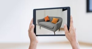 AR augmented reality. Hand holding digital tablet, AR application, simulate sofa furniture and and interior design