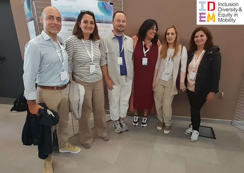 IDEM Team members are standing and smiling together while posing at the camera at Unite! Dialogue in Politecnico di Torino