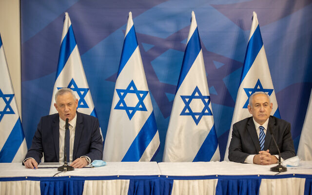 Prime Minister Benjamin Netanyahu, left and Alternate Prime Minister Defense Benny Gantz hold a press conference in Tel Aviv on July 27, 2020. (Tal Shahar/POOL/Flash90)