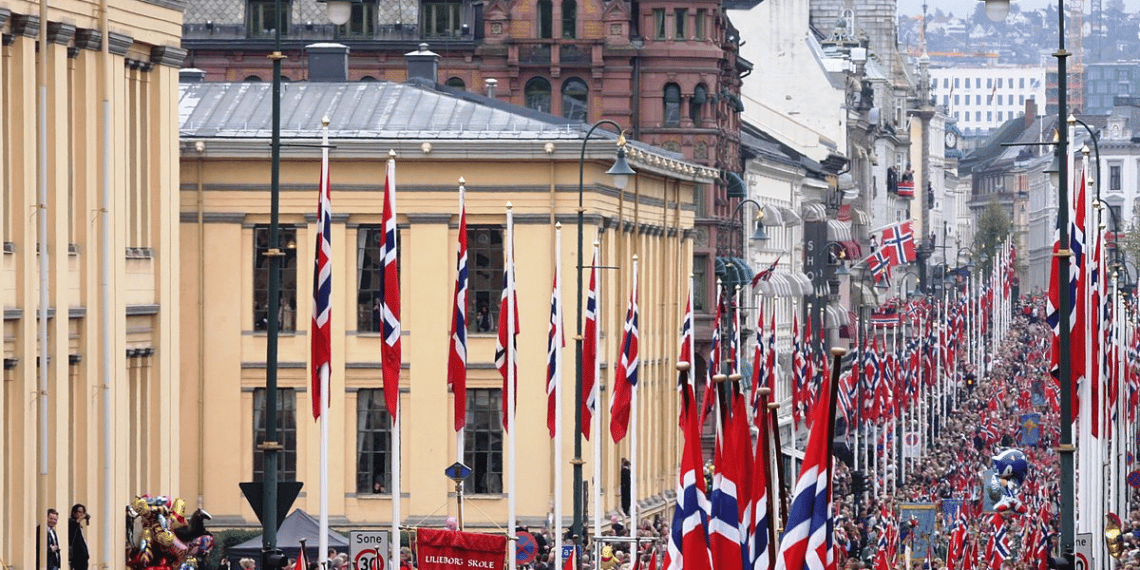 17. mai i Oslo - fra Karl Johans gate mellom Stortinget og Slottet. Foto: https://commons.wikimedia.org/wiki/User:Bjoertvedt /.
