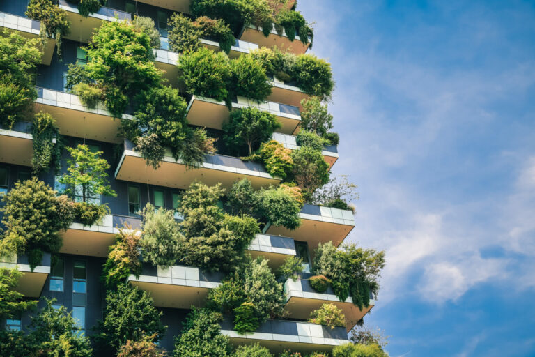 Green futuristic skyscraper Bosco Verticale, vertical forest apartment building with gardens on balconies. Modern sustainable architecture in Porta Nuova district, Milan, Italy.