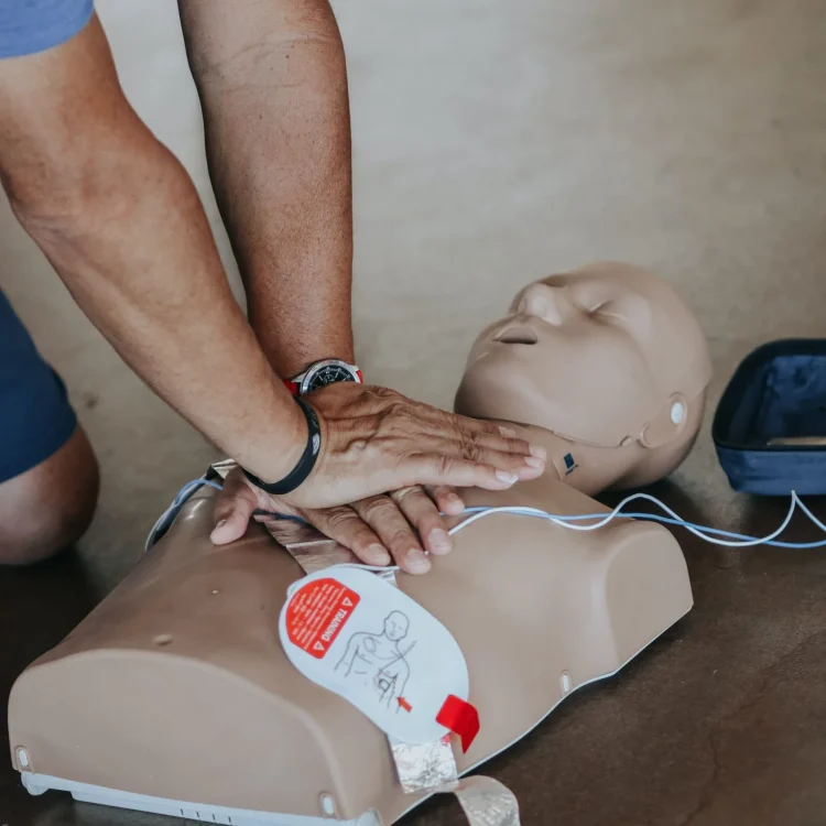 Instructor performing CPR on a dummy