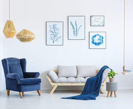 White,Sofa,And,Blue,Armchair,In,Living,Room,With,Posters