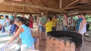 Manioc processing in a traditional casa de farinha during a caboclo house visit.