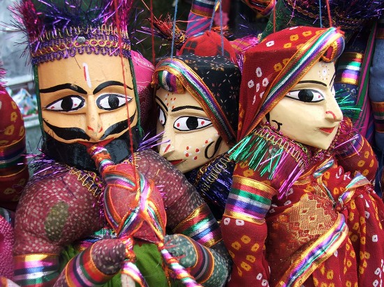 close up of colourful indian puppets with painted faces and bright clothes