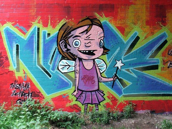 brightly painted cartoon fairy on a brick wall