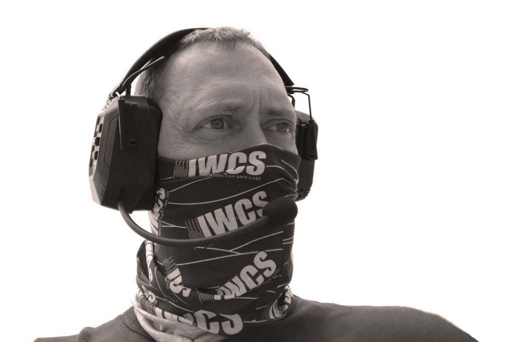 Man with IWCS headset and neckerchief over his face