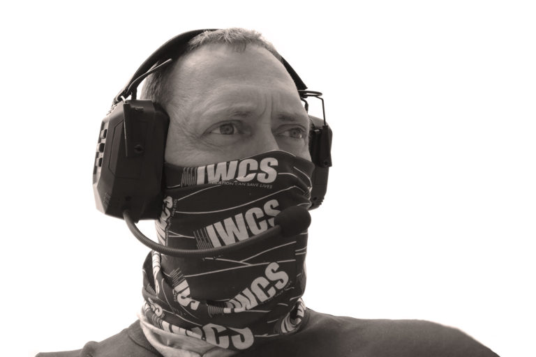 Man with IWCS headset and neckerchief over his face