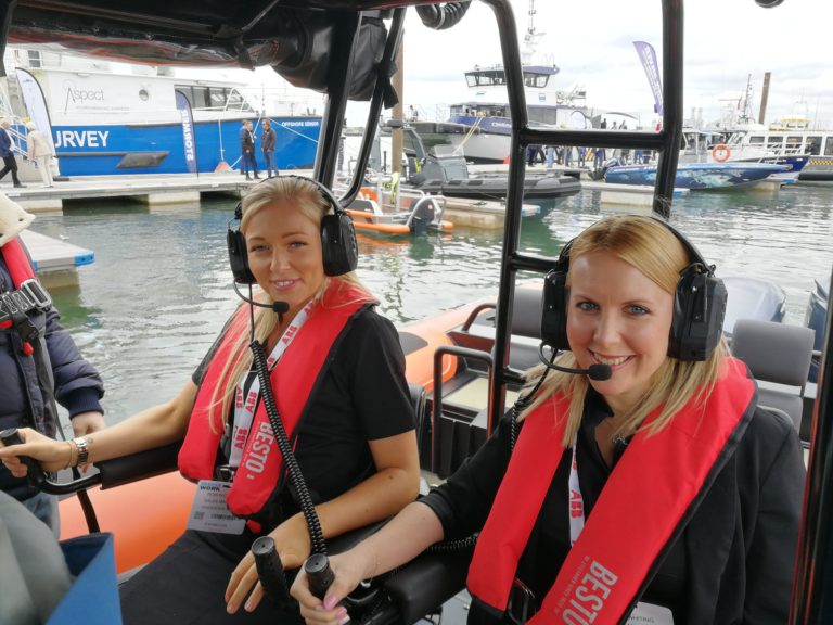 Two girls geared up with iwcs equipment on a boat