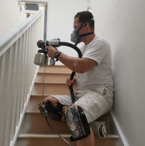 Craig decorating some spindles using a spray gun.