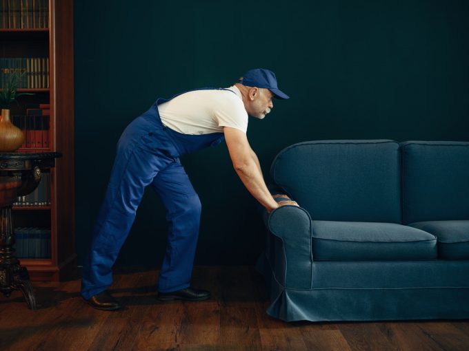 elderly-cargo-man-in-uniform-moves-sofa.jpg