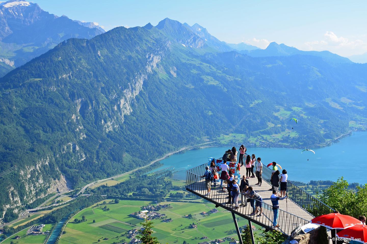 visitors enjoy the view from the Harder Kulm platform over Interlaken