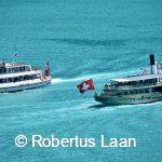 two boats cross at an azure Lake Brienz