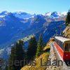 The Schynige Platte train with snow covered mountains