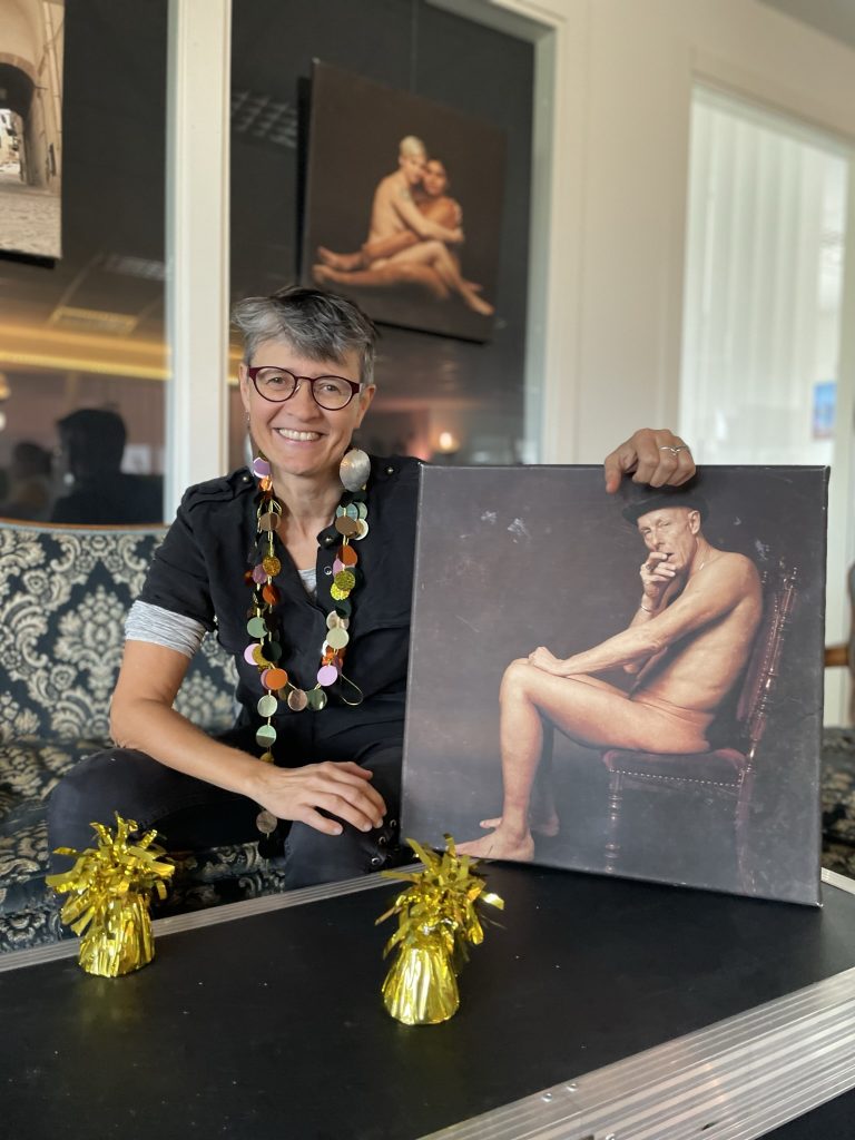 Photographer Cornelia Schmidt holding up her first picture JUST ME