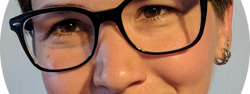 Close-up face woman brown, short hair, big black glasses